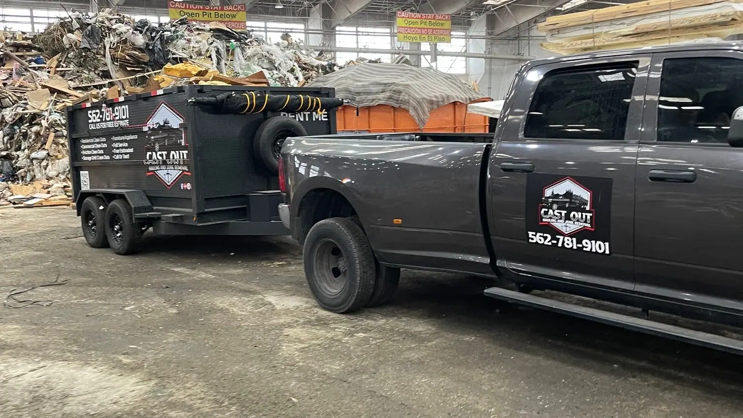 Louie's truck and Cast Out dump trailer inside the transfer station with sorted piles behind them