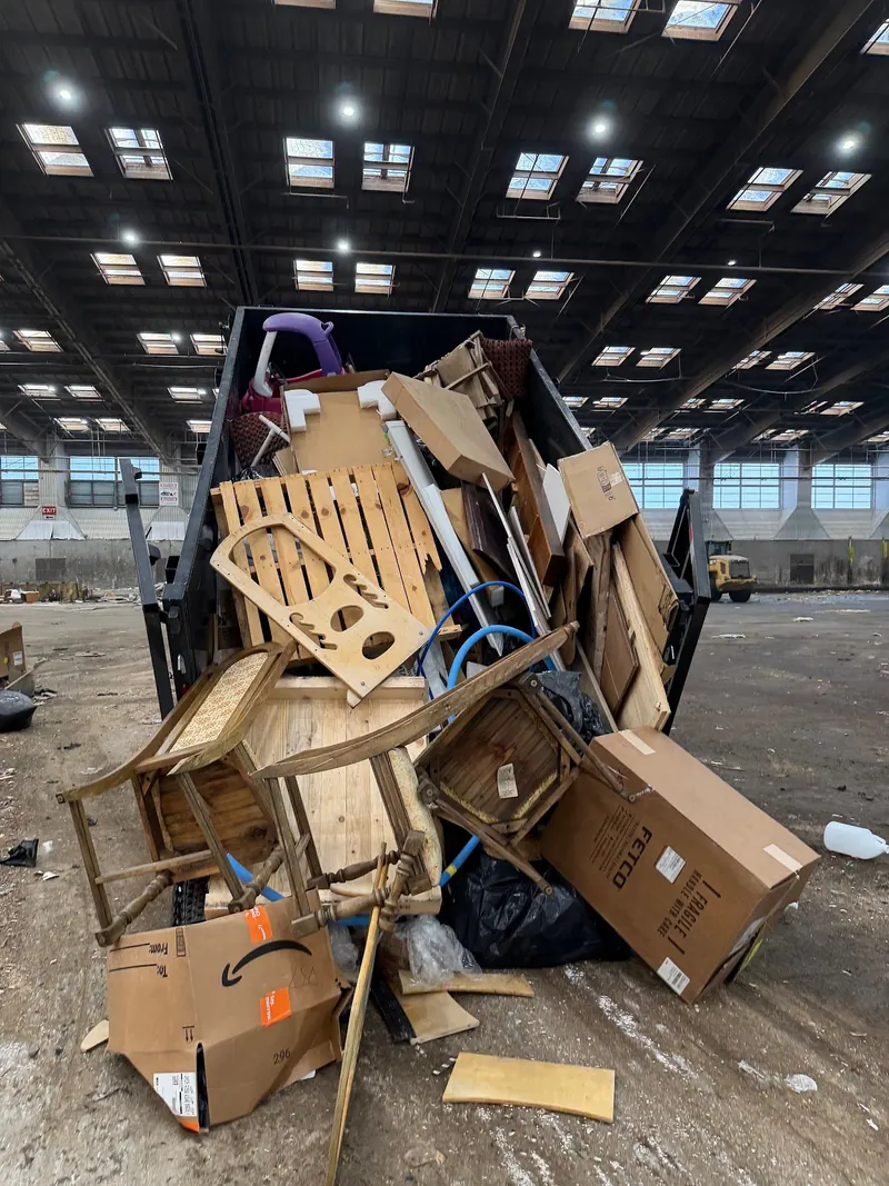 Cast Out dump trailer loaded with old chairs; wood furniture and boxes at the transfer station